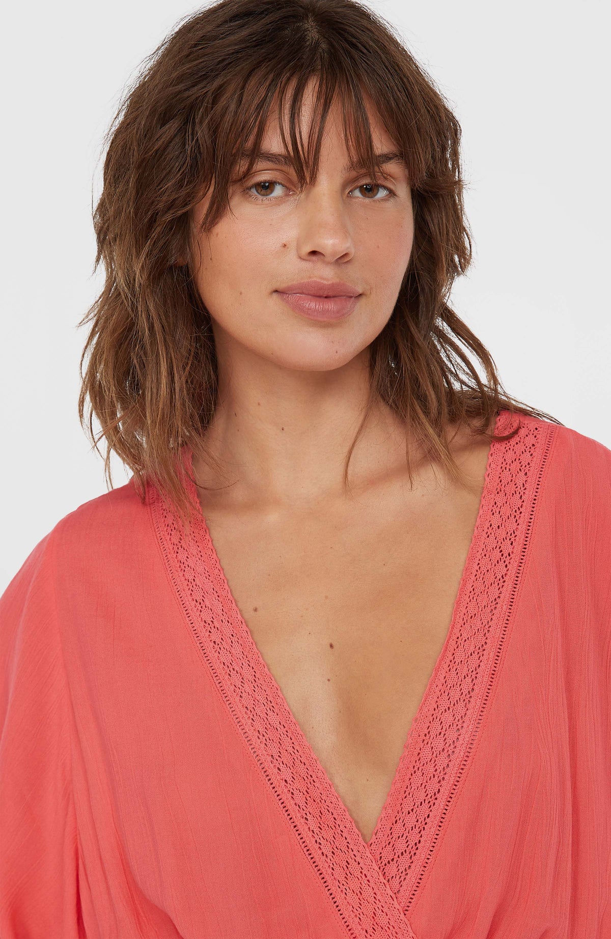 Nahaufnahme des pinken Essentials Cover Up Kleids mit Spitzenborte am tiefen V-Ausschnitt