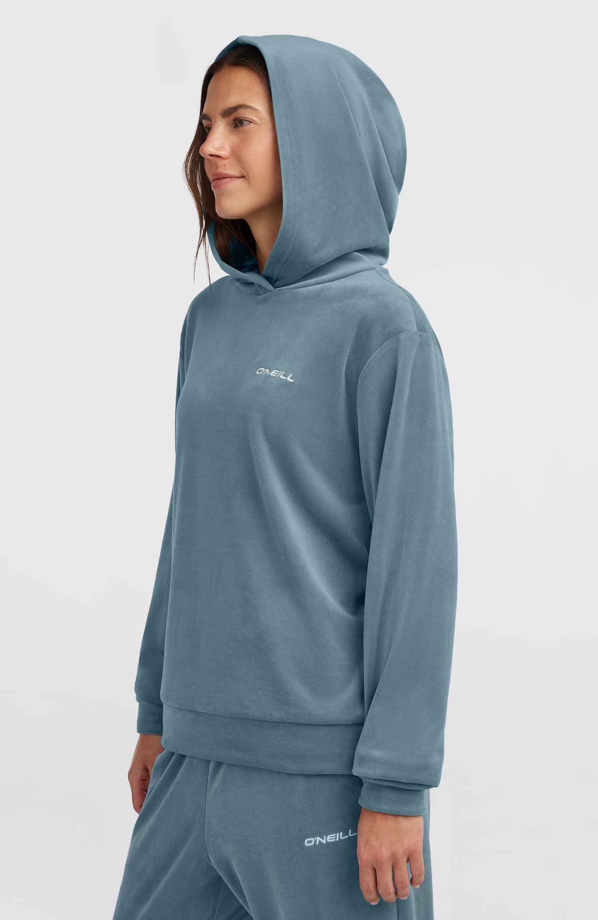 FWC'Cruz Velour Hoodie für Damen, blau, Seitenansicht getragen am Model mit aufgesetzter Kapuze