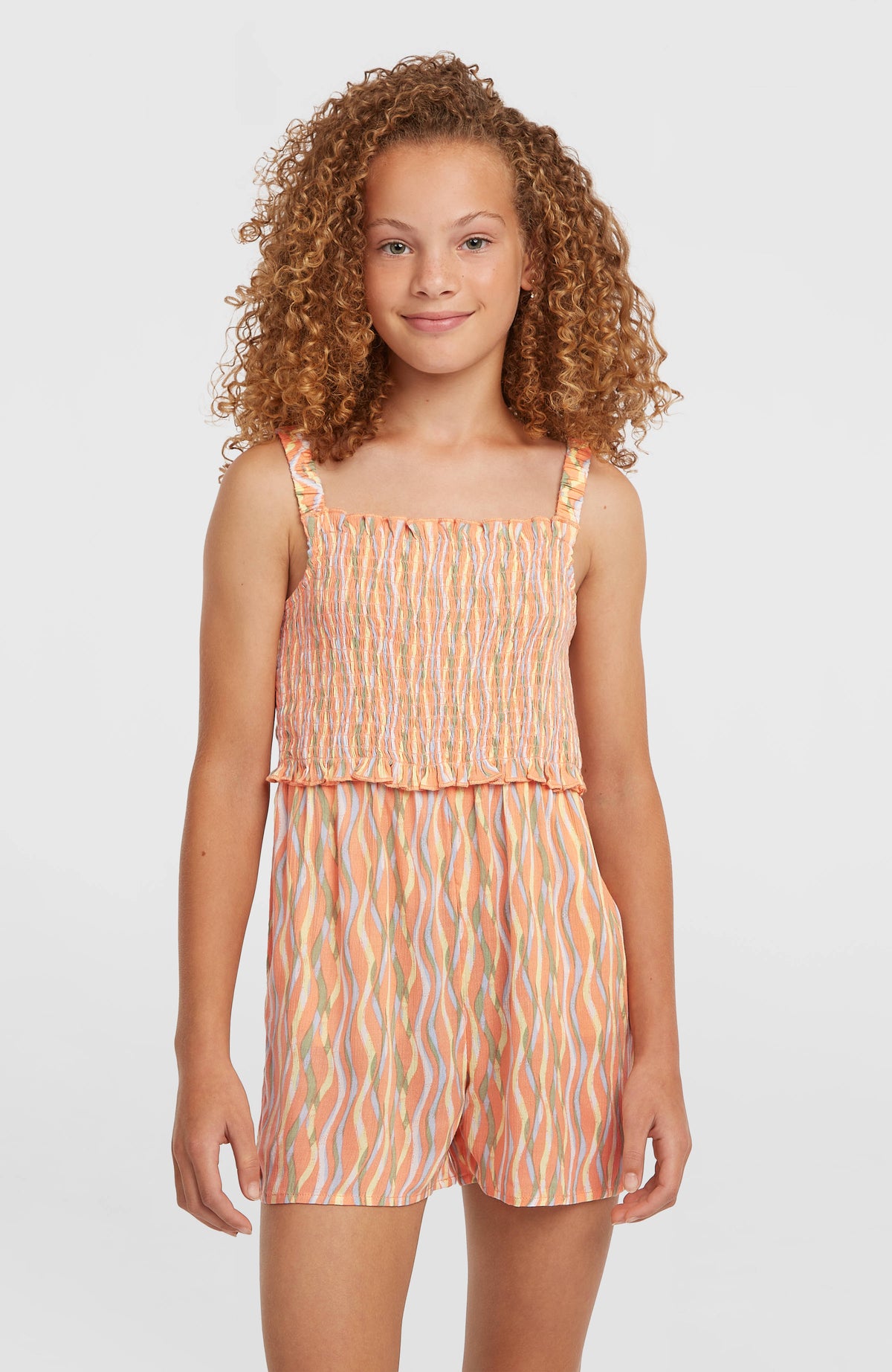 O'Neill Woven Playsuit für Mädchen, orange mit Wellenmuster in Gelb und Grün, Vorderansicht am Model