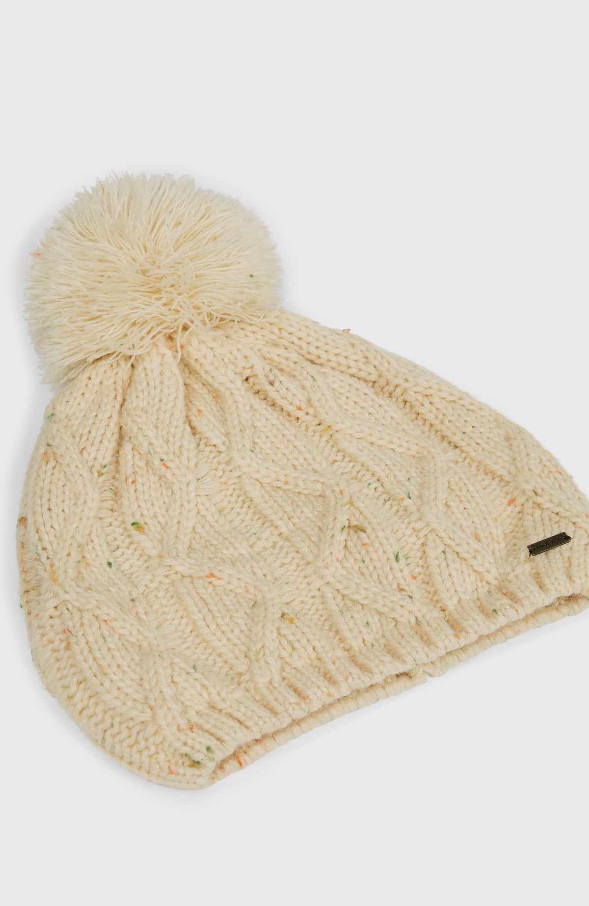 Nora Mütze für Mädchen, beige, freigestellt von schräg oben, Nahaufnahme von Strickmuster und Logo-Badge