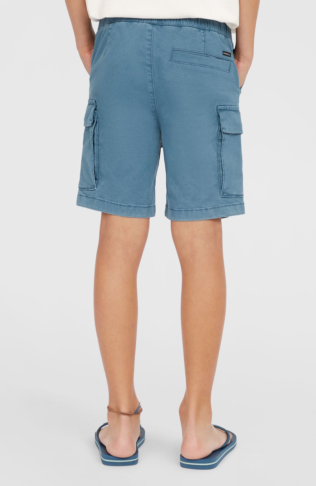 Cargo-Shorts für Jungen, blau, Rückansicht am Model mit Gesäßtasche und Logo-Patch