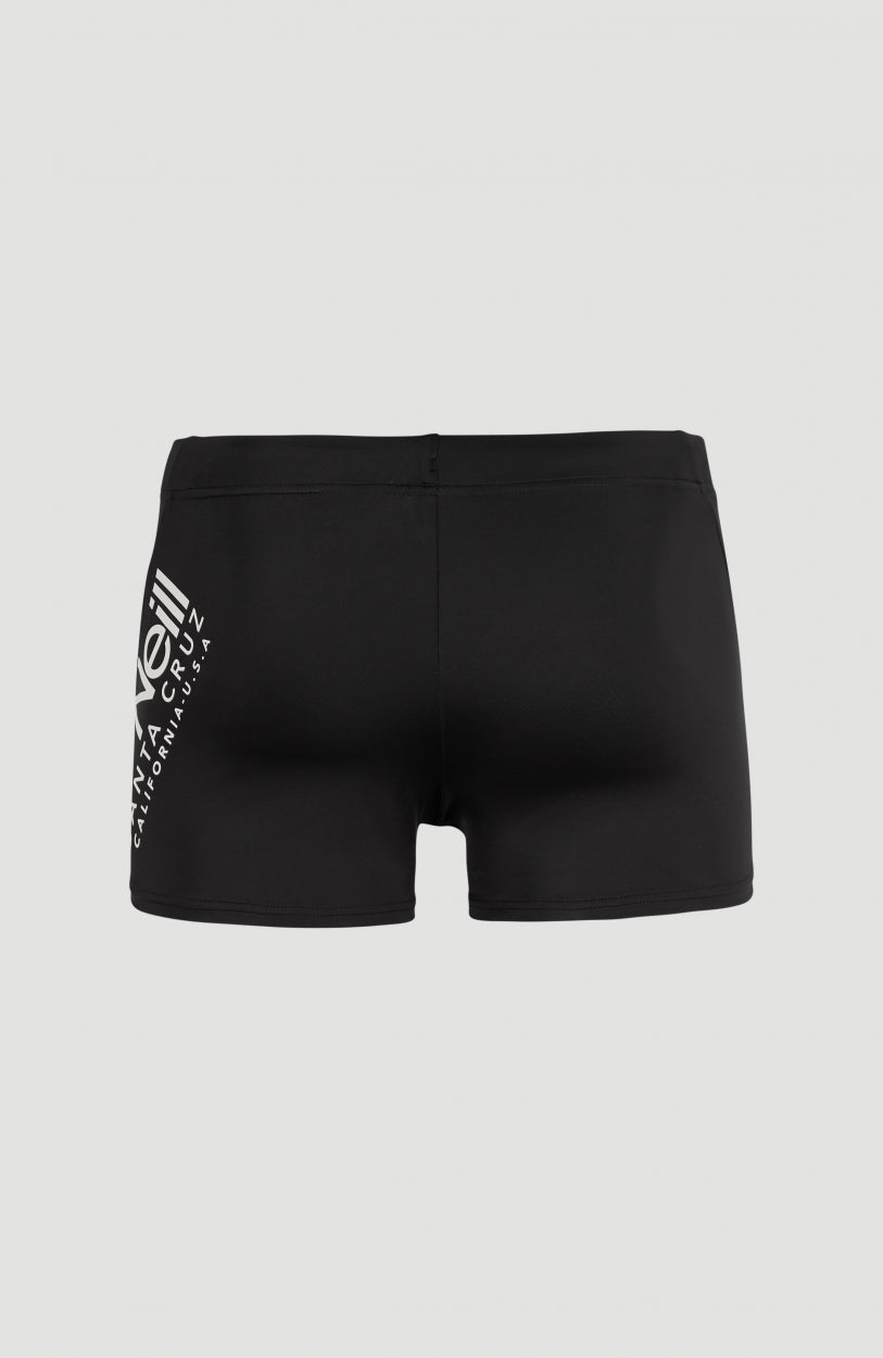 Essentials Cali Racer Badehose für Herren, schwarz, Rückansicht mit weißem Logo-Print an der Seite