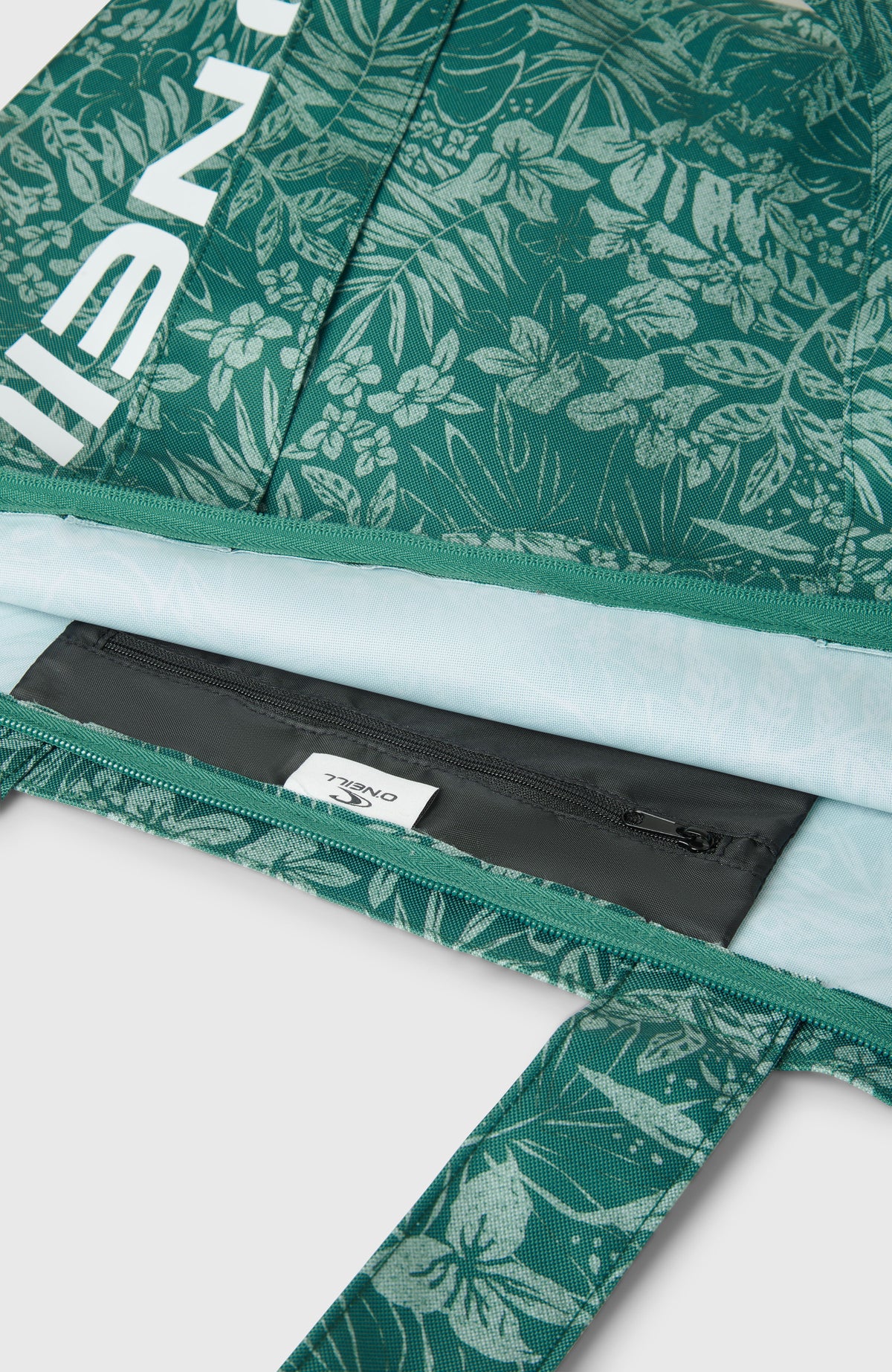 Nahaufnahme vom Innenfach mit Reißverschluss der grünen Coastal Print Tote Bag Tasche mit Pflanzenmuster