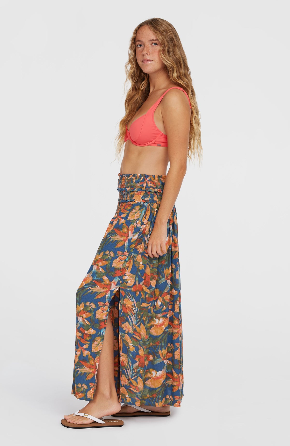 Devyn Maxirock für Damen, blau mit Blumenmuster in Orange und Gelb, Seitenansicht am Model mit seitlichem Schlitz