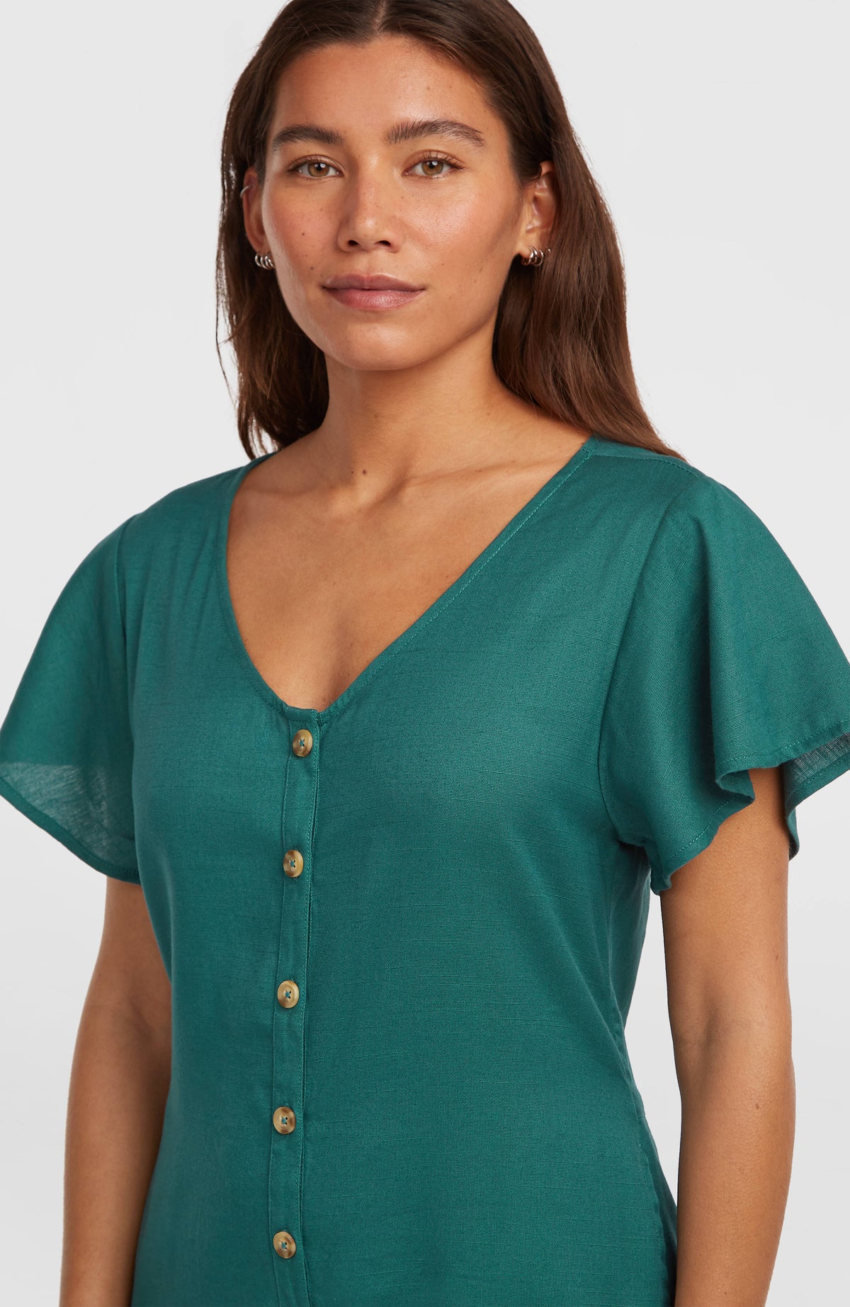 O'Riginals Playsuit für Damen, grün, Nahaufnahme am Model mit tiefem V-Ausschnitt, Knopfleiste und Flatterärmeln