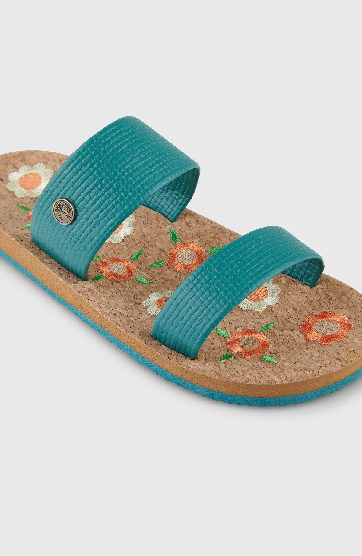 Nahaufnahme der grünen O'Riginals Slides mit Blumenmuster in Orange und Weiß, Riemen mit rundem Logo-Badge