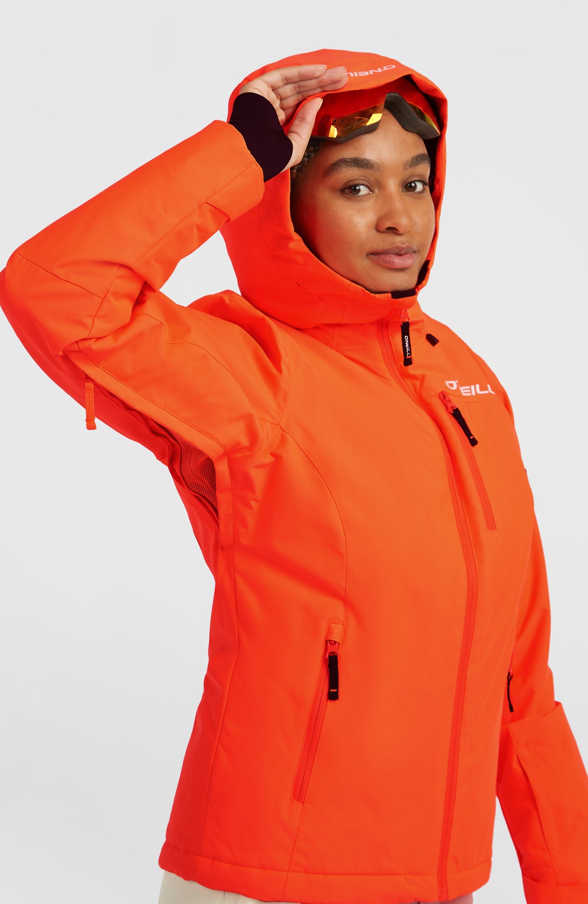 FWC'Cruz Skijacke für Damen, rot, Halbprofil am Model mit aufgesetzter Kapuze und Belüftungsschlitz