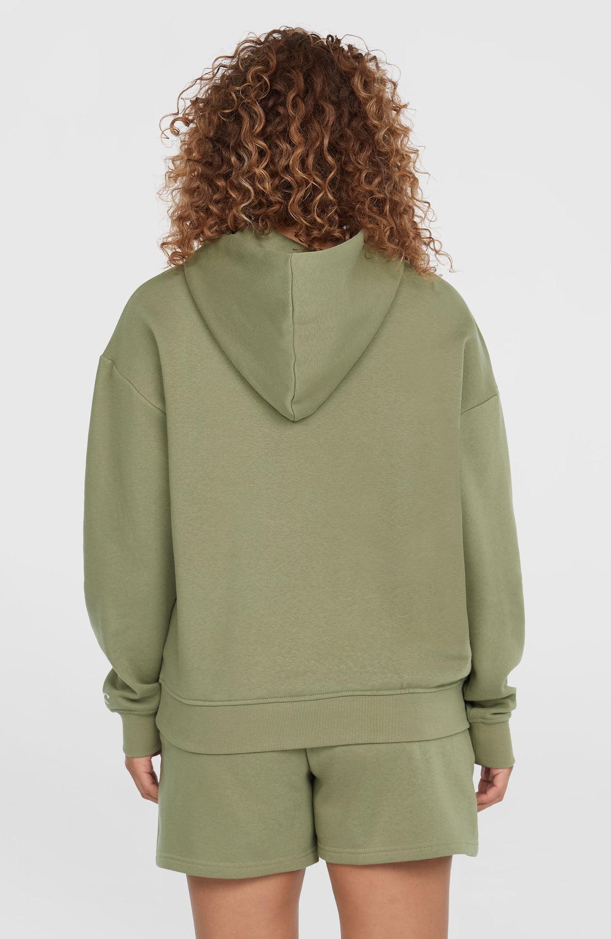Future Surf Society Hoodie für Damen, grün, Rückansicht am Model mit angesetzter Kapuze und Saumbund