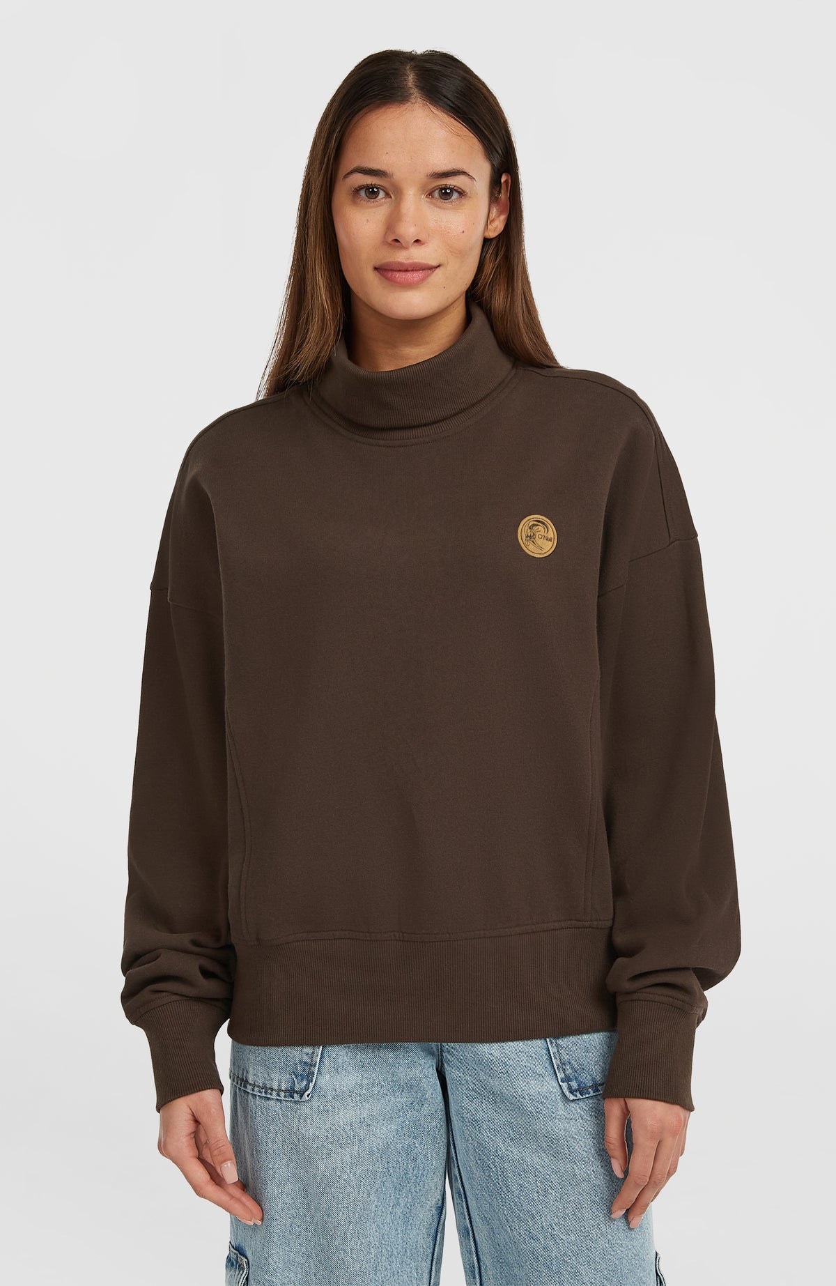 O'Riginals Crew Sweatshirt für Damen, braun, Vorderansicht am Model mit rundem Logo-Patch auf der Brust