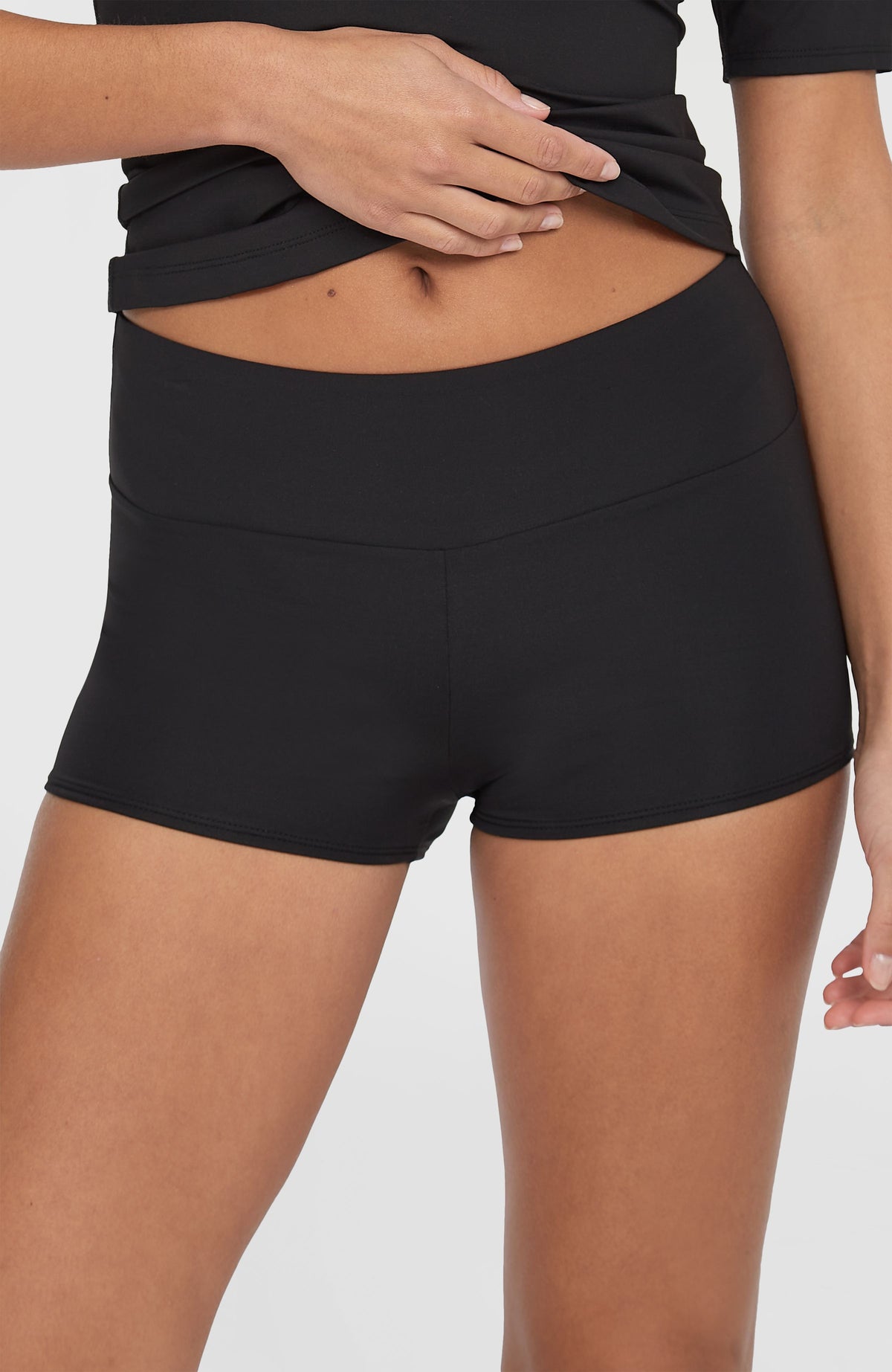 Nahaufnahme des hohen Bundes der schwarzen Grenada Bikinihose für Damen, getragen am Model von vorne