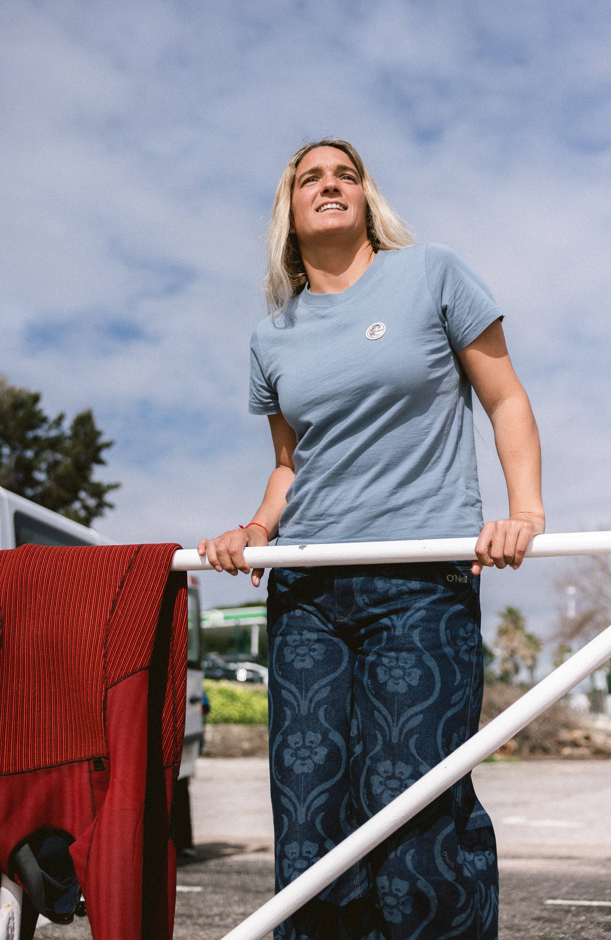 O'Neill O'Riginals Badge T-Shirt für Damen, blau, getragen im Freien an einem Geländer