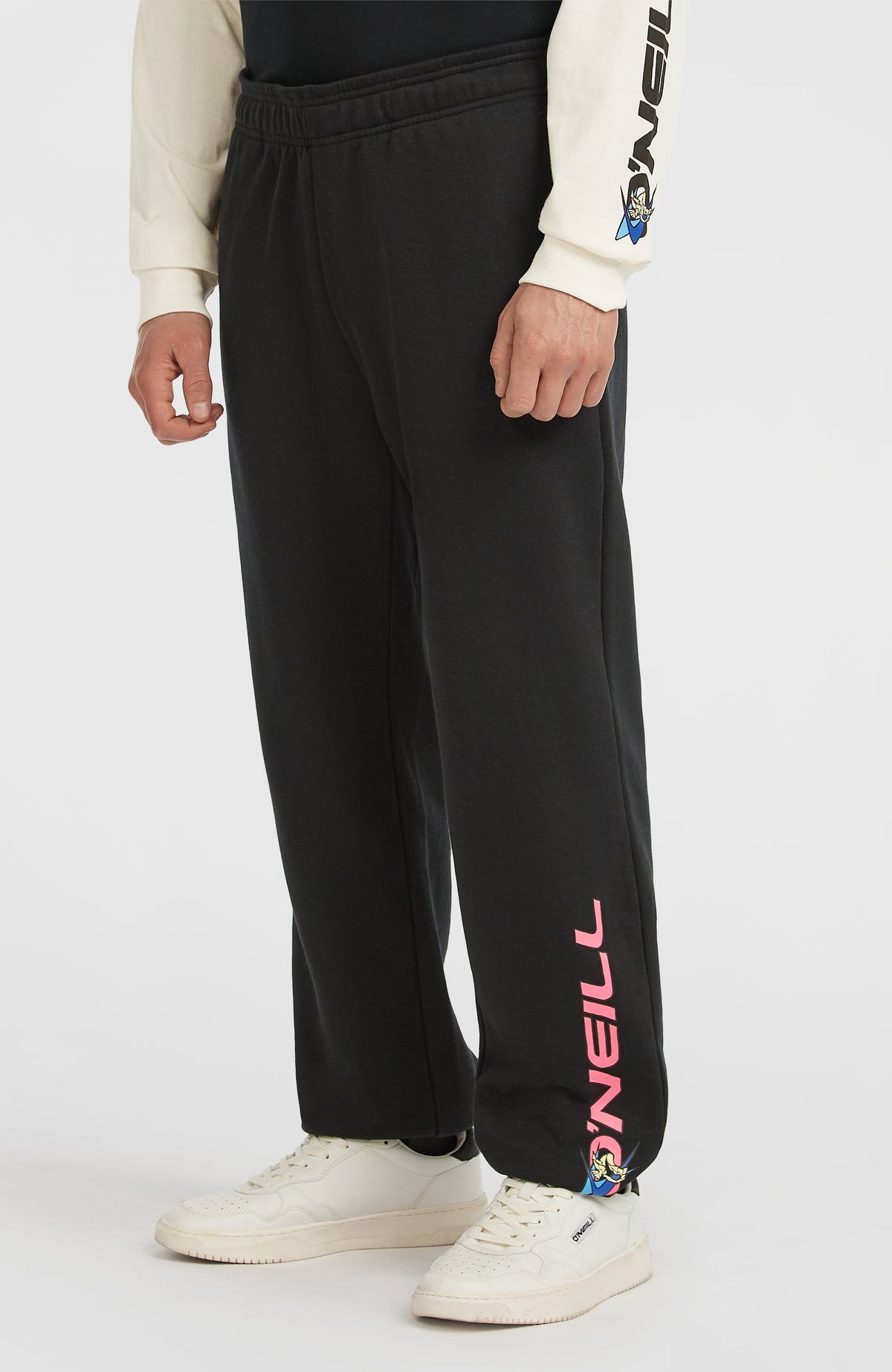 FWC'Play Jogginghose für Herren, schwarz mit Logo-Print in Pink, Dreiviertelansicht am Model von der Seite