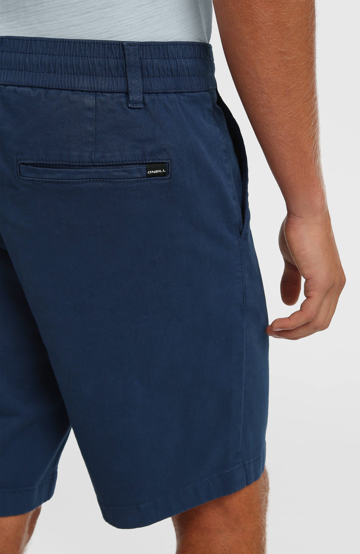 Essentials Chino-Shorts für Herren, blau, Nahaufnahme der hinteren Tasche mit kleinem Logo-Label am Model