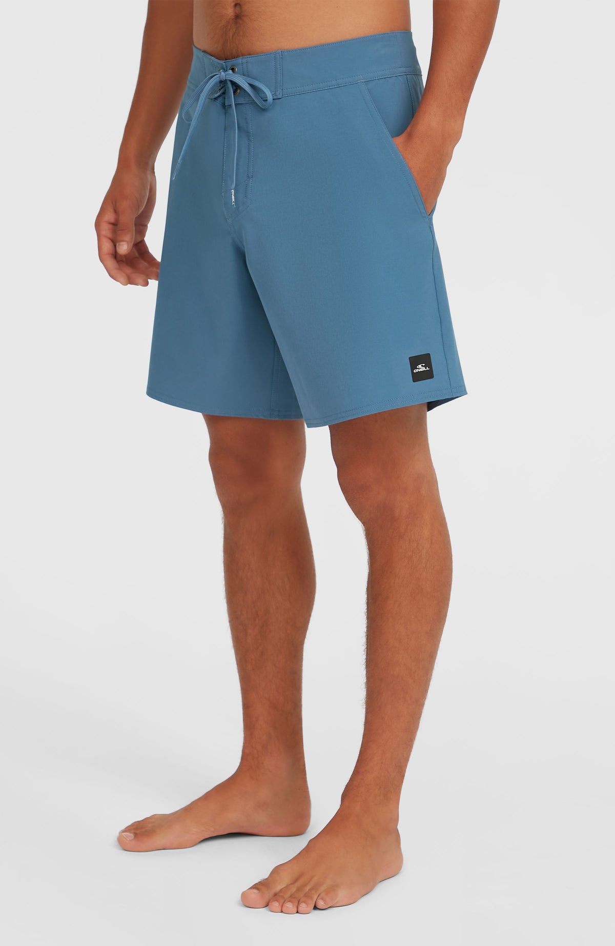 Solid 17'' Boardshorts für Herren, blau, Halbprofilansicht am Model mit Logo-Patch am Saum