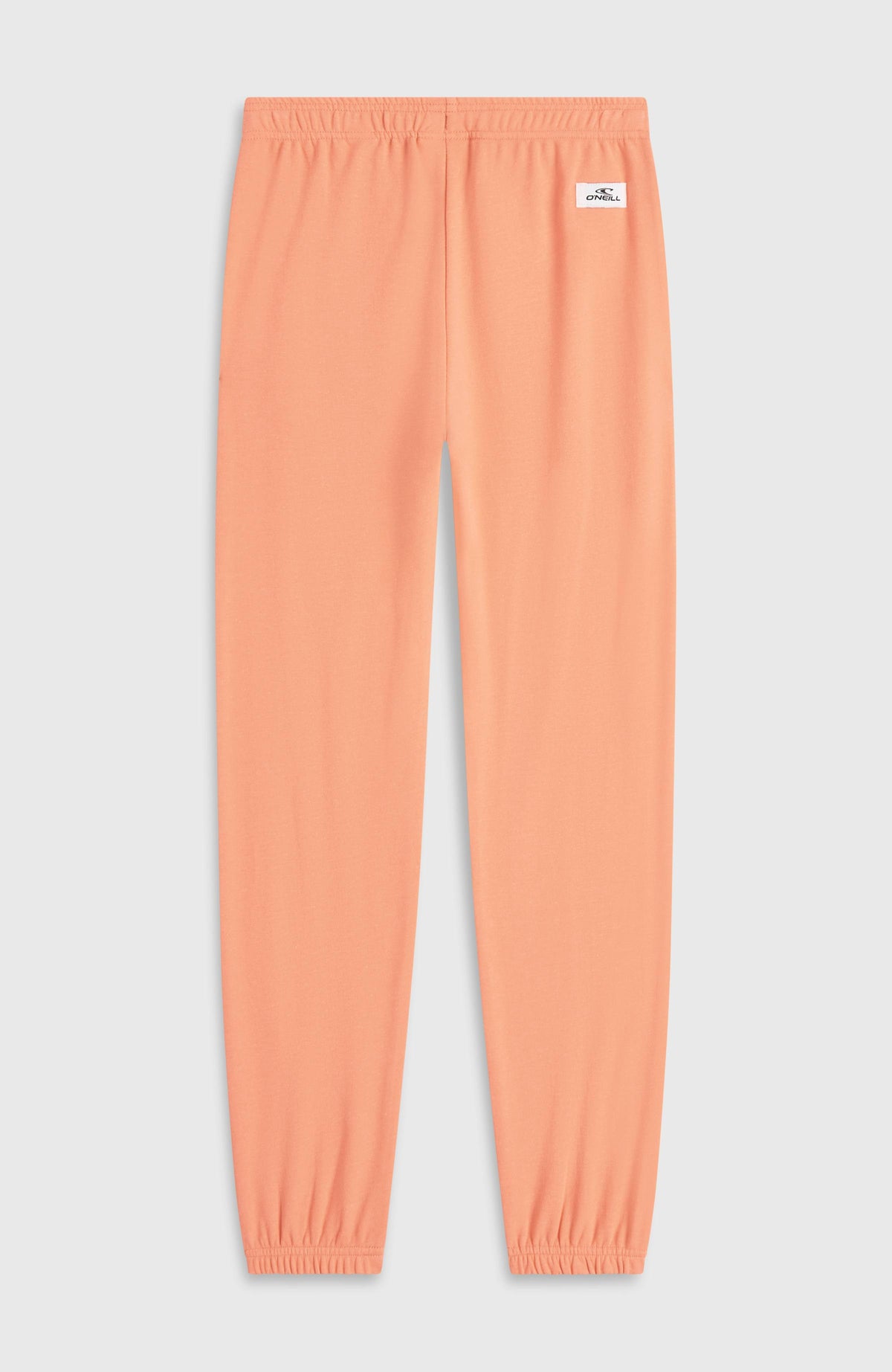 Essentials Jogginghose für Mädchen, orange, flach liegend von hinten mit kleinem Logo-Patch am Bund
