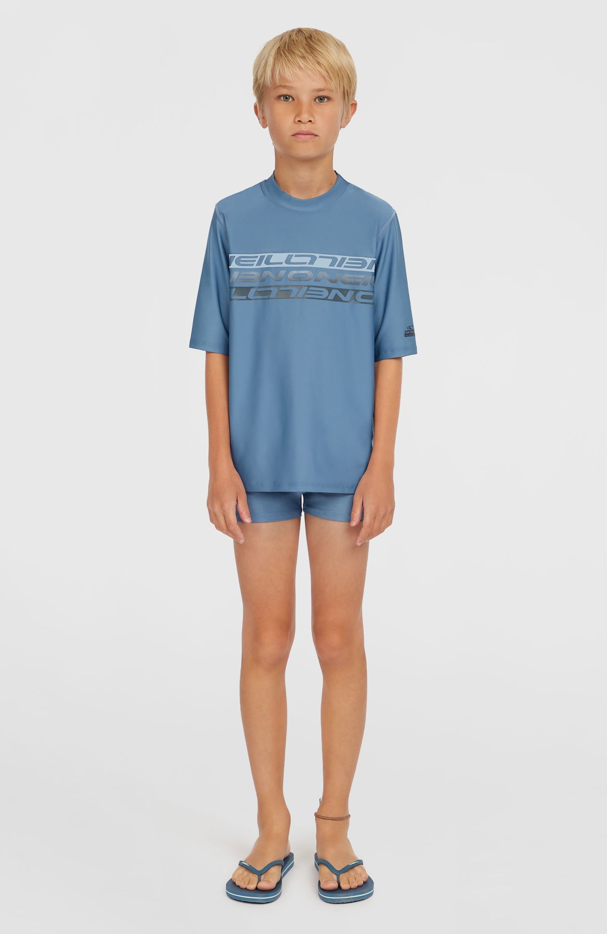 Blaues Shortsleeve-Schwimmshirt für Jungen mit Logo-Print in Hellblau und Dunkelgrau, Ganzkörperansicht am Model